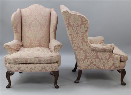A pair of George III style mahogany wing armchairs, H.3ft 7in.